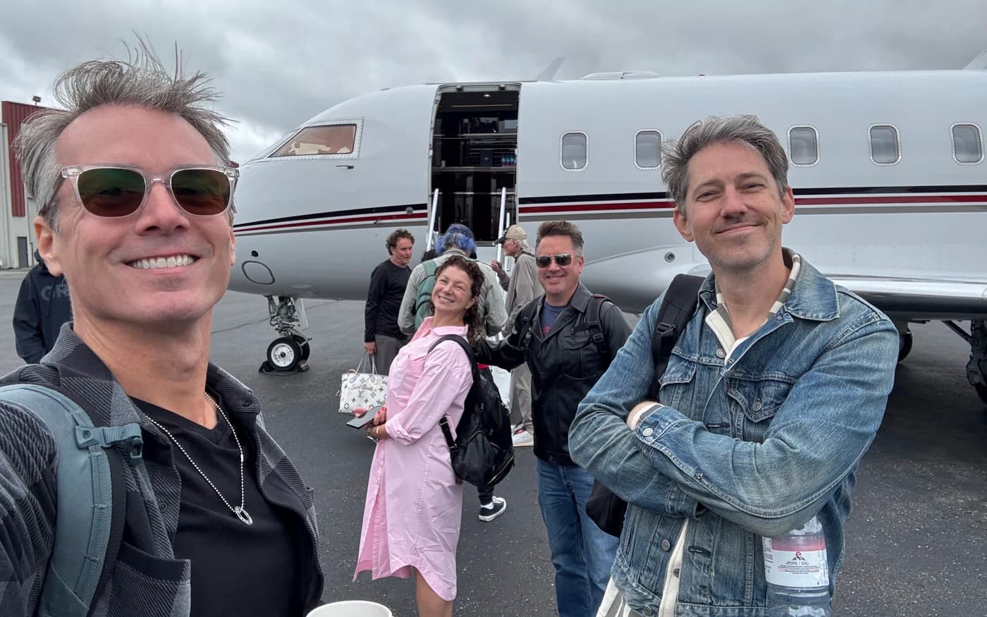 Brian Eichenberger and Chris Cron beside a plane on tour with The Beach Boys